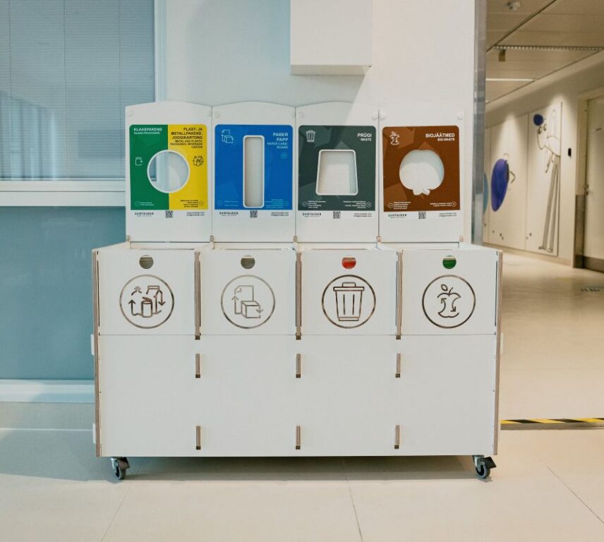 Recycling bins for hospitals with clear labels for glass, plastic, paper, waste, and bio waste.