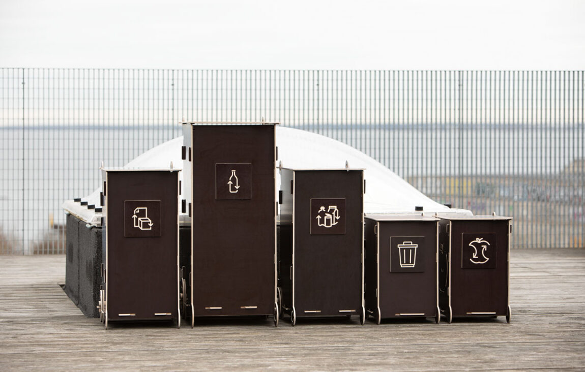 Modern wooden waste bins for home use with separate compartments for glass, packaging, mixed, and bio waste.