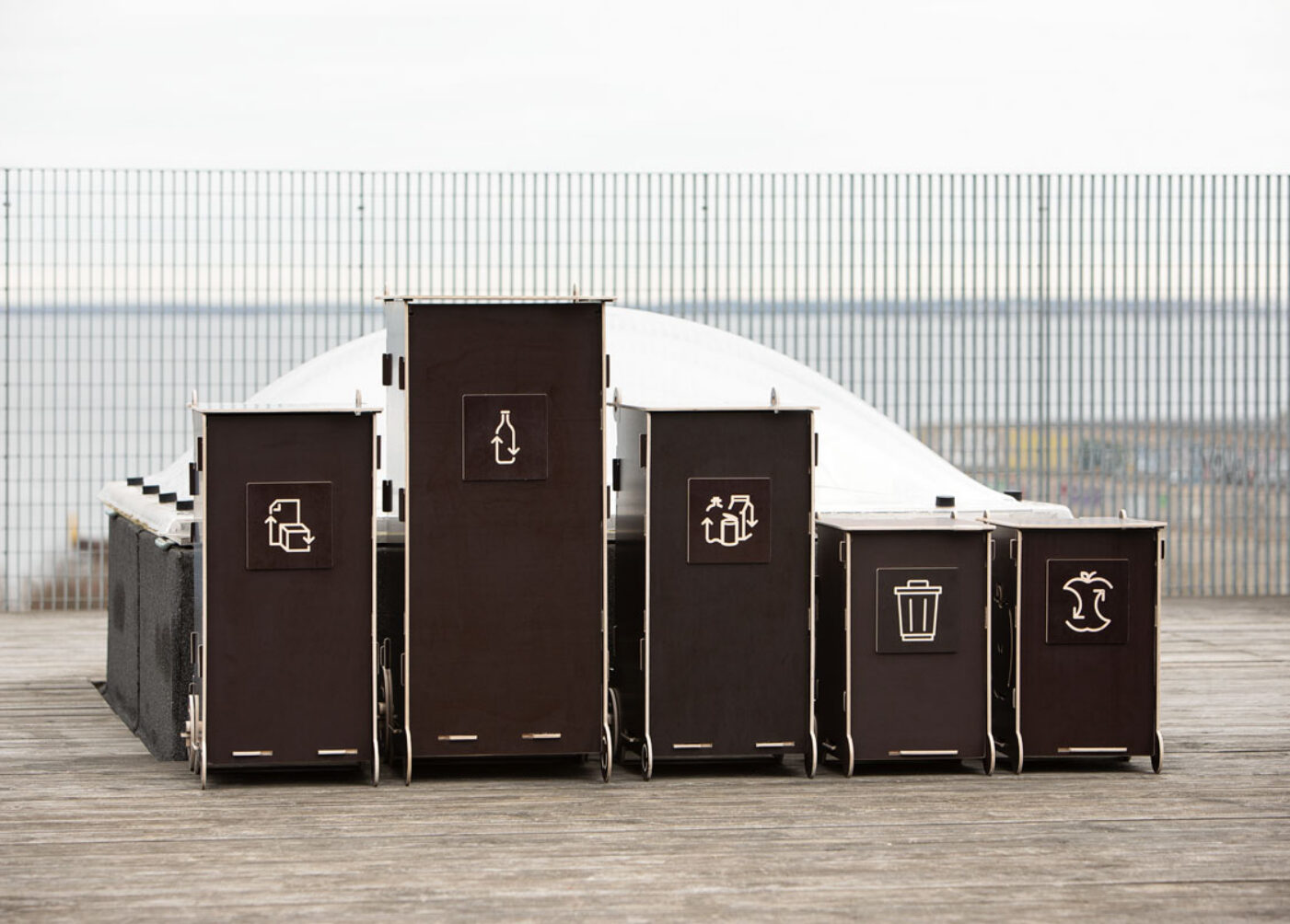 Modern wooden waste bins for home use with separate compartments for glass, packaging, mixed, and bio waste.