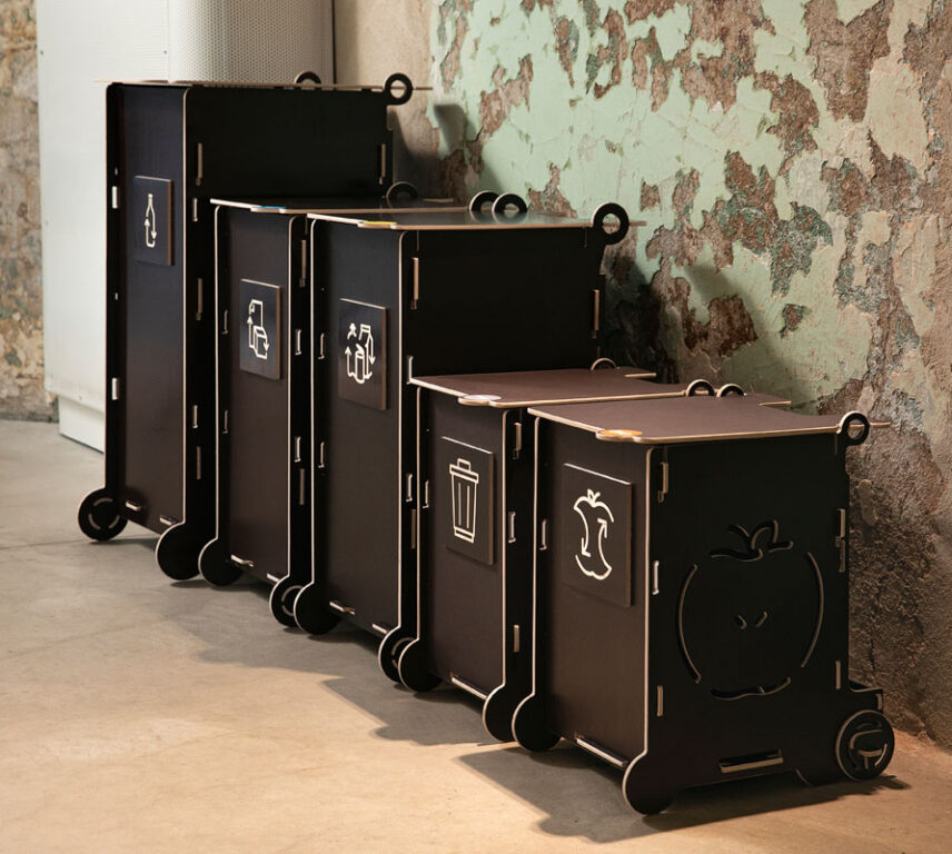 Black office waste bins with lids and recycling symbols, featuring separate sections for paper, packaging, mixed, and bio waste.
