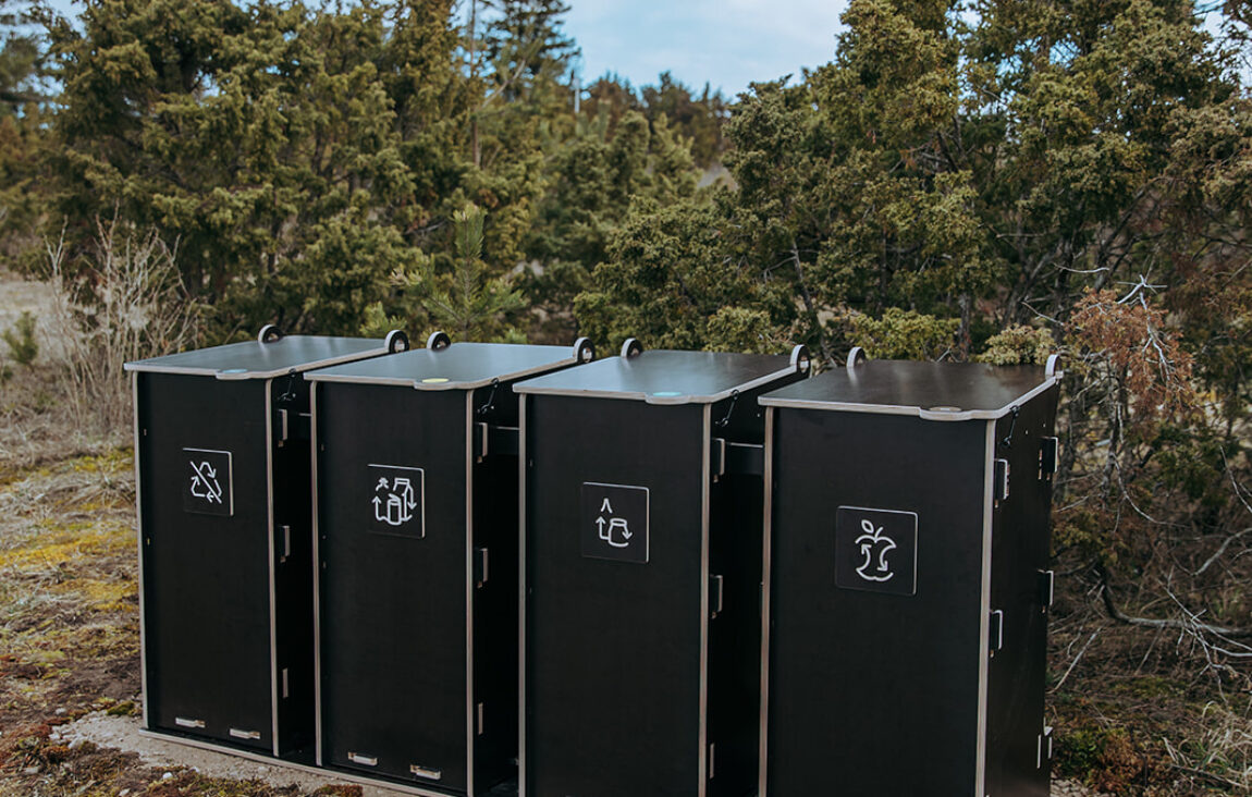 Durable outdoor waste bins with multiple compartments for sorting glass, paper, packaging, and bio waste in public areas.