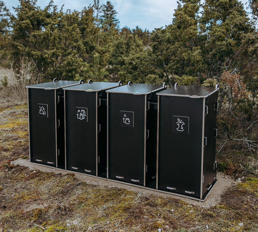 Durable outdoor waste bins with multiple compartments for sorting glass, paper, packaging, and bio waste in public areas.