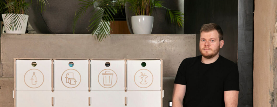 Modern white waste sorting station with multiple compartments for recycling, designed with an award-winning sustainable approach.