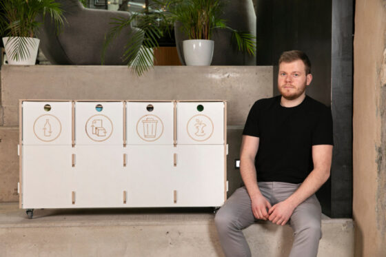 Modern white waste sorting station with multiple compartments for recycling, designed with an award-winning sustainable approach.