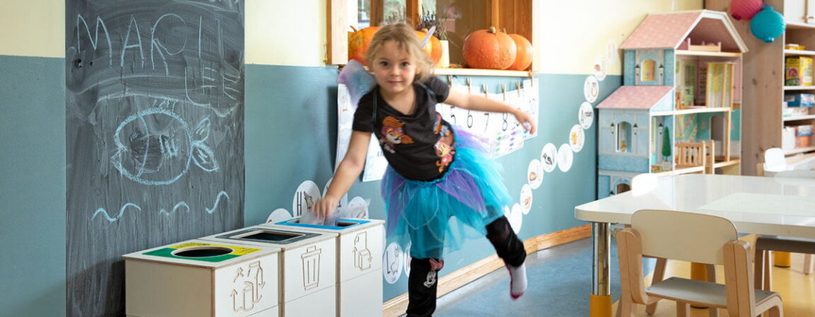 Child using Sortaider waste sorting bins in a classroom – promoting eco-friendly habits