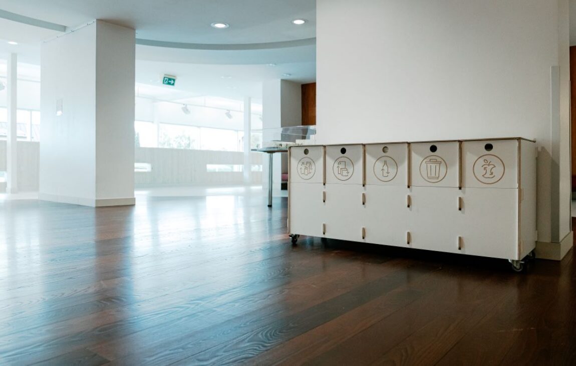 Recycling bins for office corridors placed along a hallway to support quick and intuitive waste sorting.