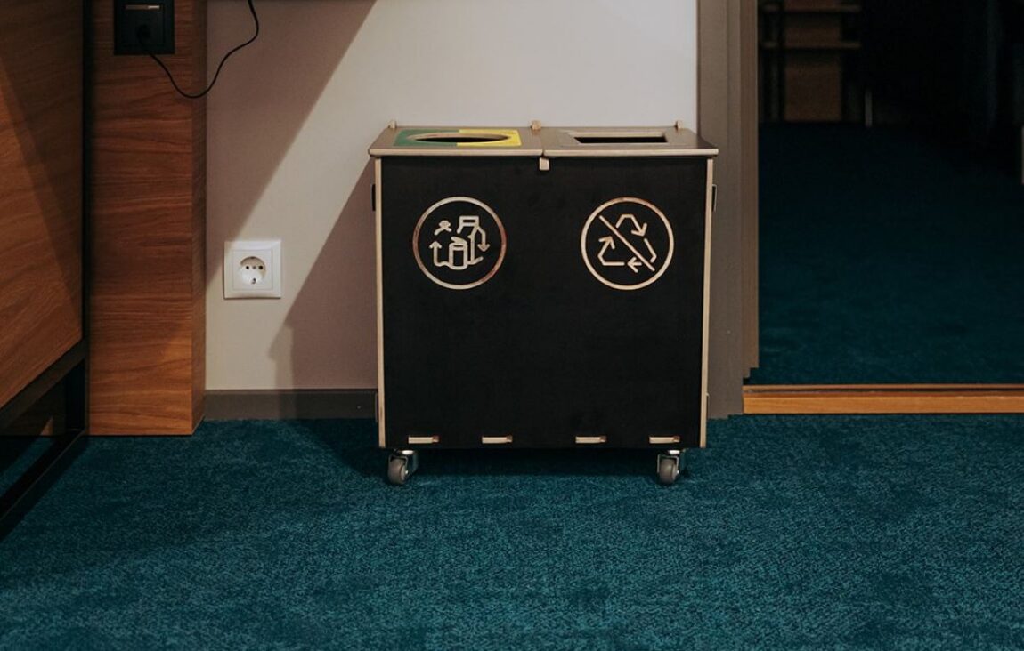 Recycling bins for small businesses in a compact workplace sorting area.