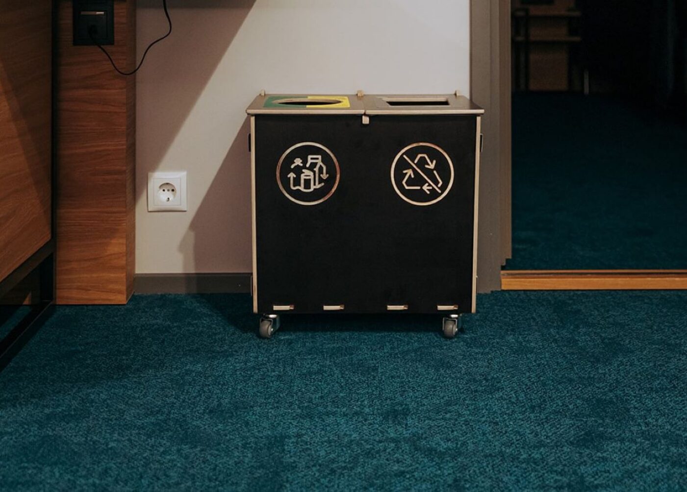 Recycling bins for small businesses in a compact workplace sorting area.