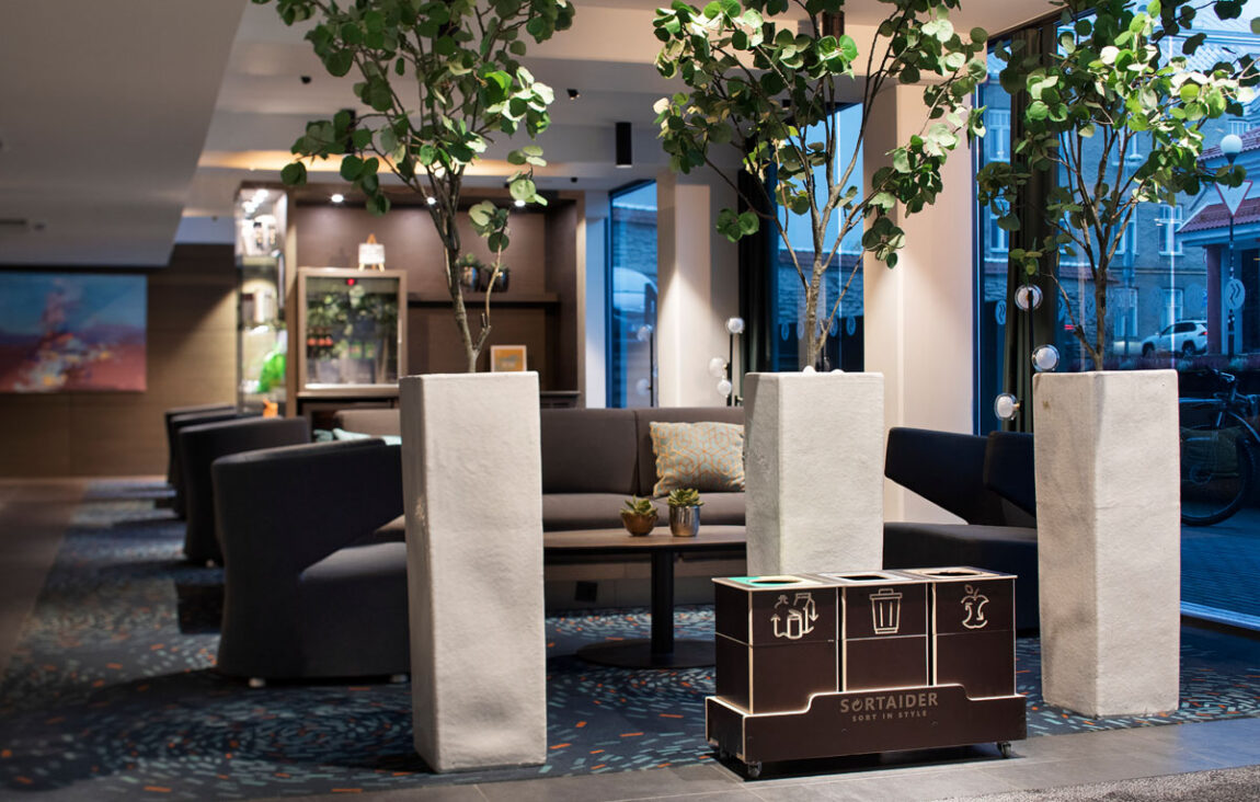 Recycling bins for sustainable offices placed in a shared workspace to make waste sorting feel effortless.