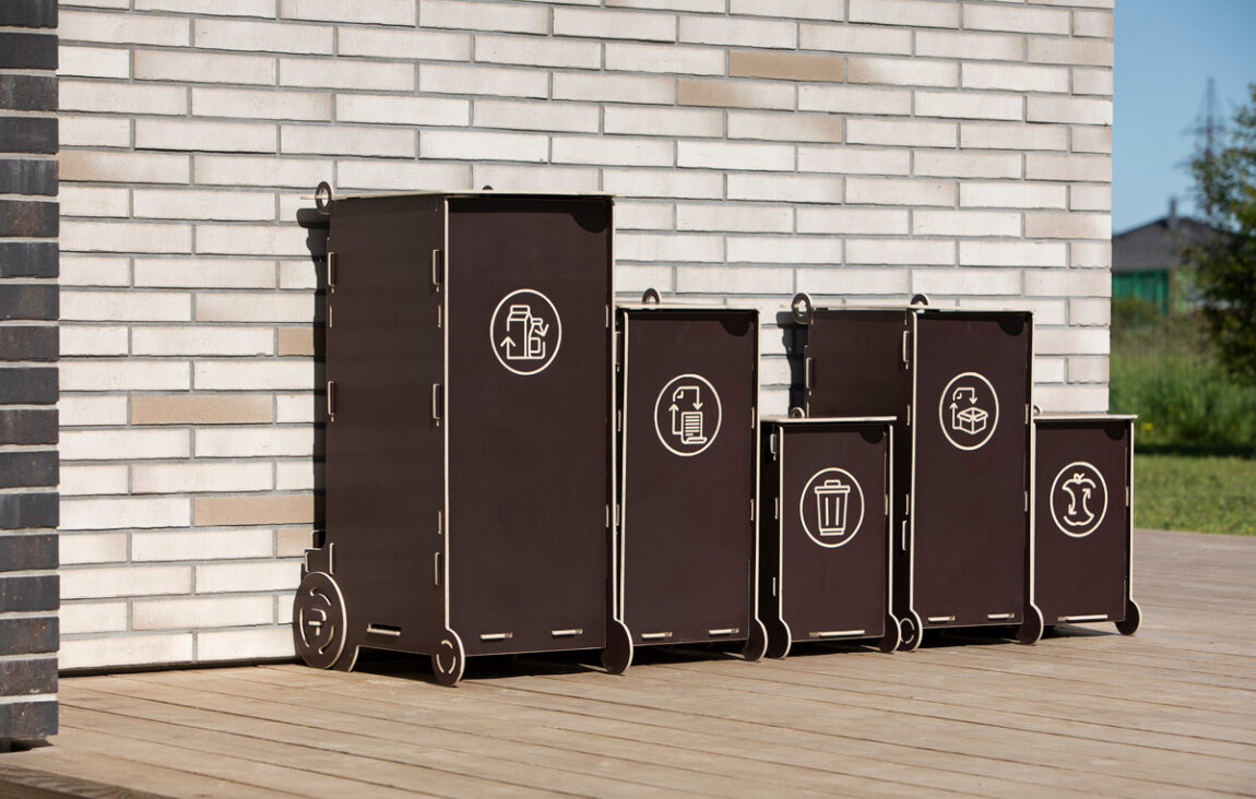 Waste bins used in a home setting to separate recyclables from general household waste.