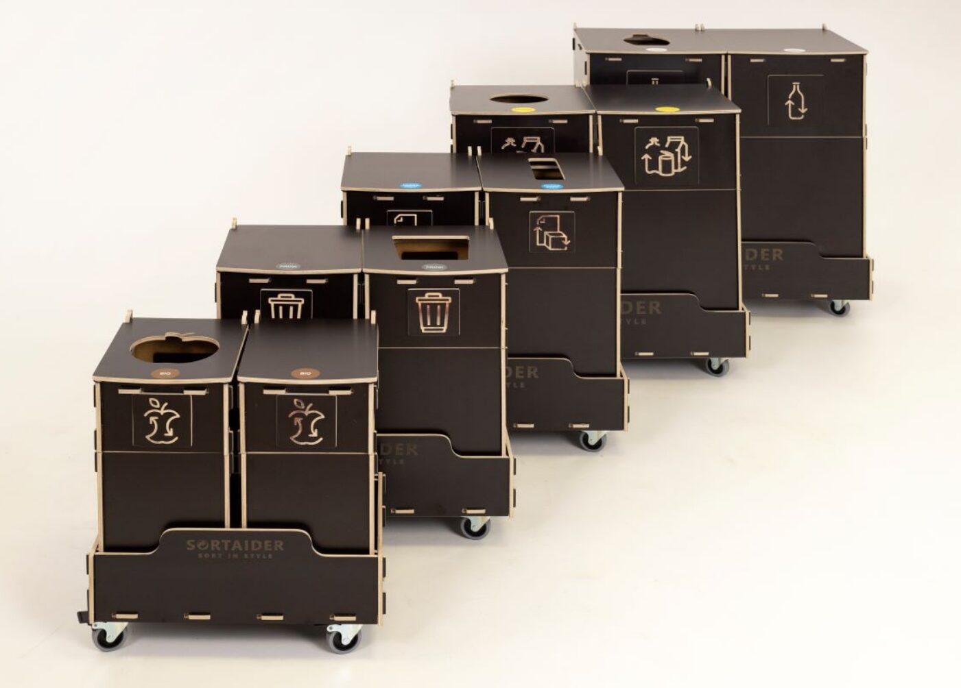 Waste bins for office lounges placed in a relaxed seating area to support casual waste sorting.