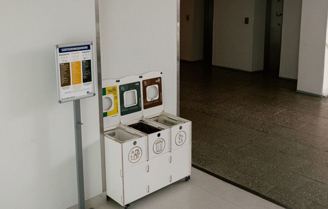 Labeled recycling bins in a school promoting easy trash removal and proper waste sorting for students.