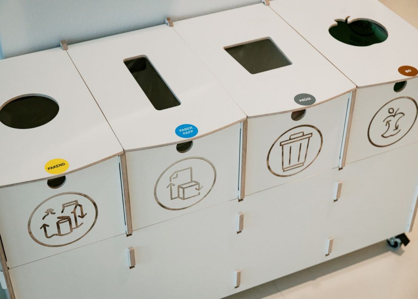 Recycling bins for sustainable waste sorting in kindergarten are used by children to sort paper and cardboard promoting sustainable recycling and effective waste management