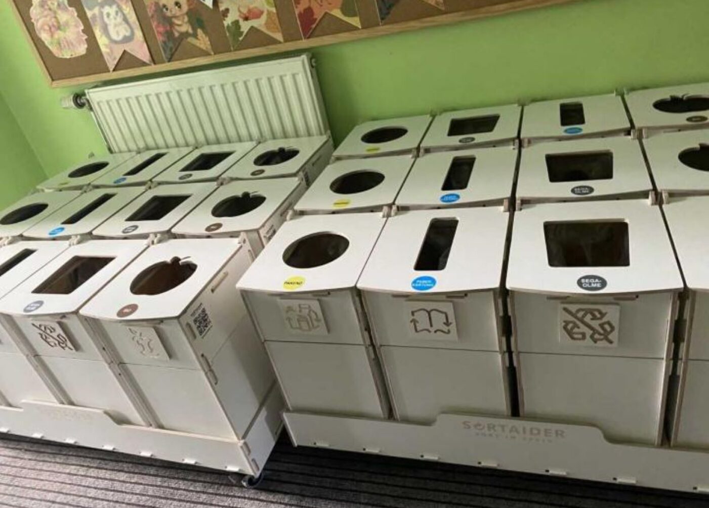 Recycling bins and waste sorting stations in kindergarten high traffic areas, helping children learn proper waste separation.