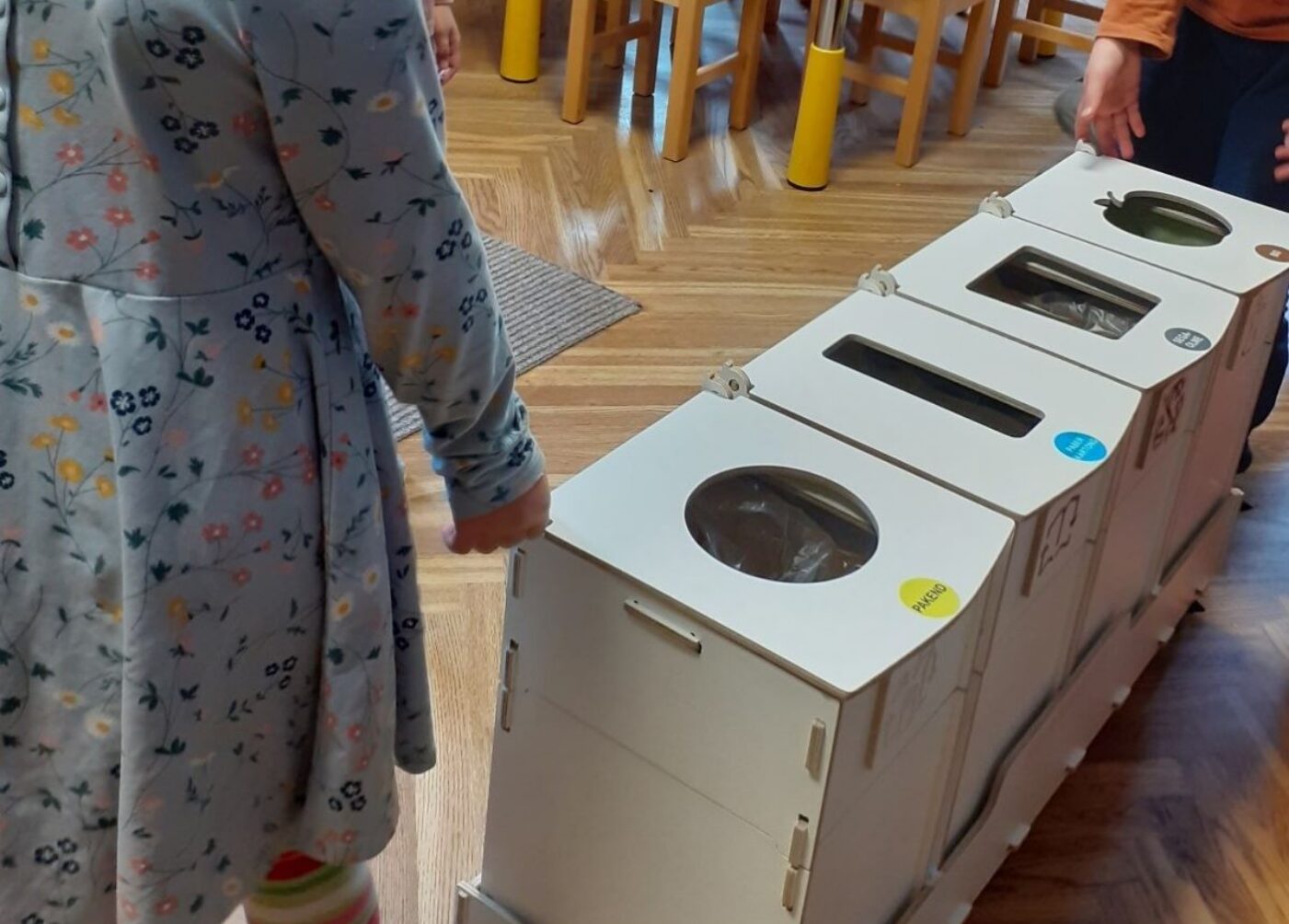 Recycling bins and waste sorting stations in a Tallinn kindergarten classroom, helping children learn proper waste separation.