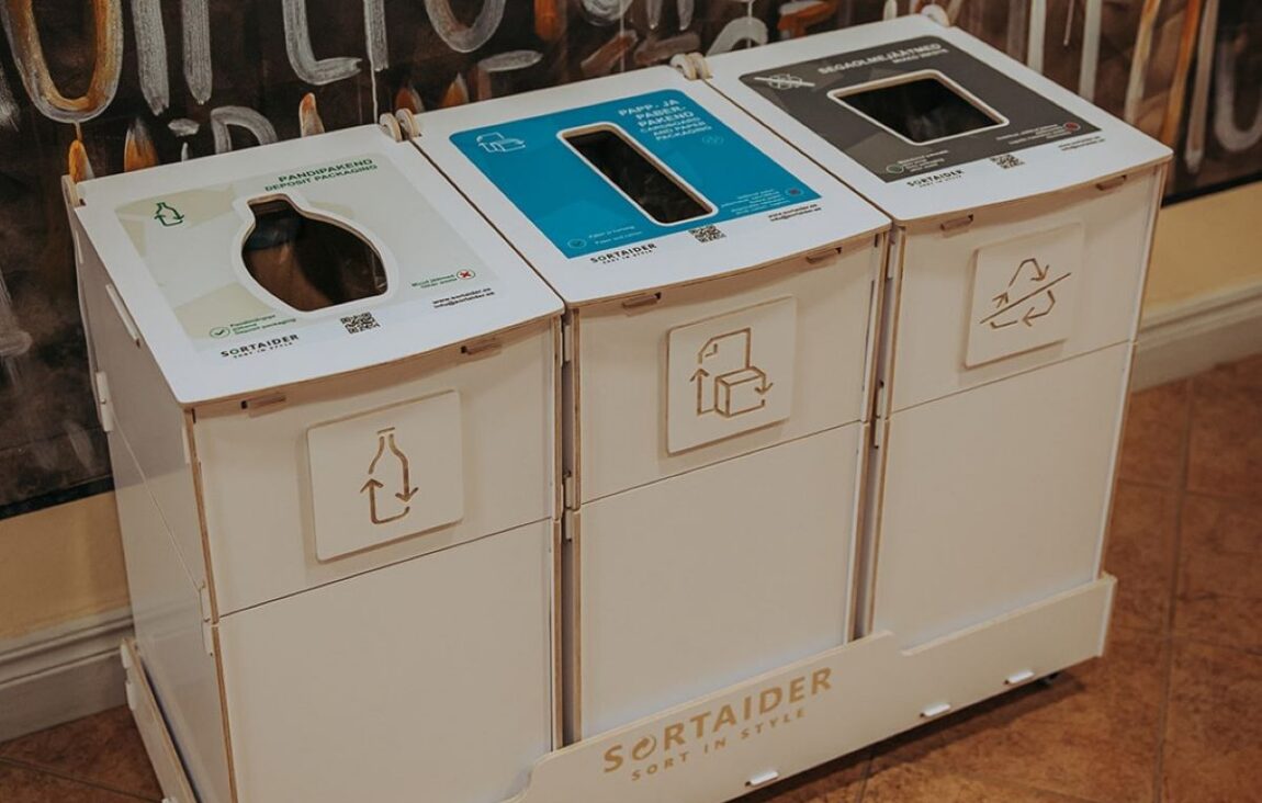 Waste sorting cans in the library are used by visitors to sort paper, cardboard, and general trash, demonstrating easy recycling and supporting efficient waste management.